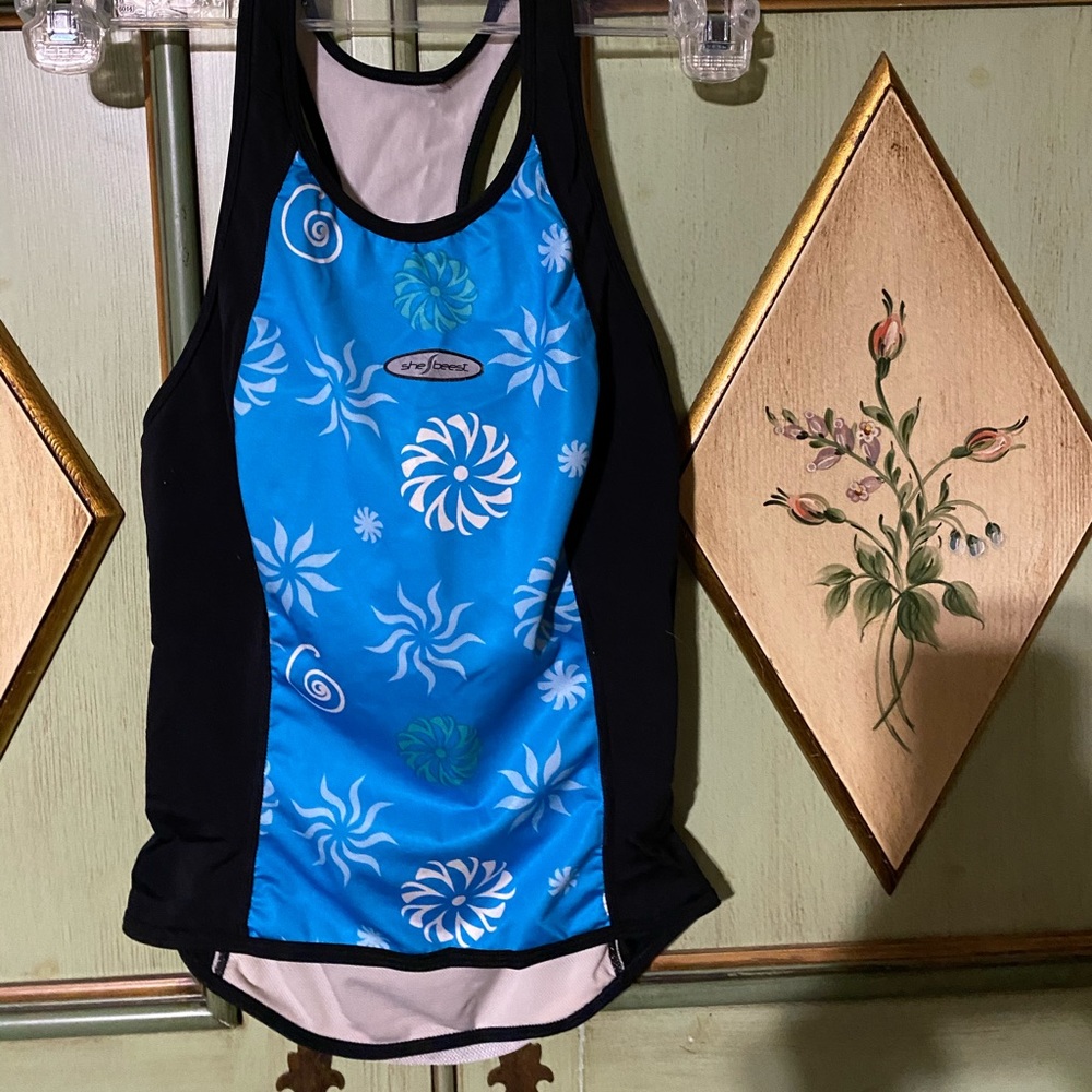 SheBeest Bicycle jersey or workout top.